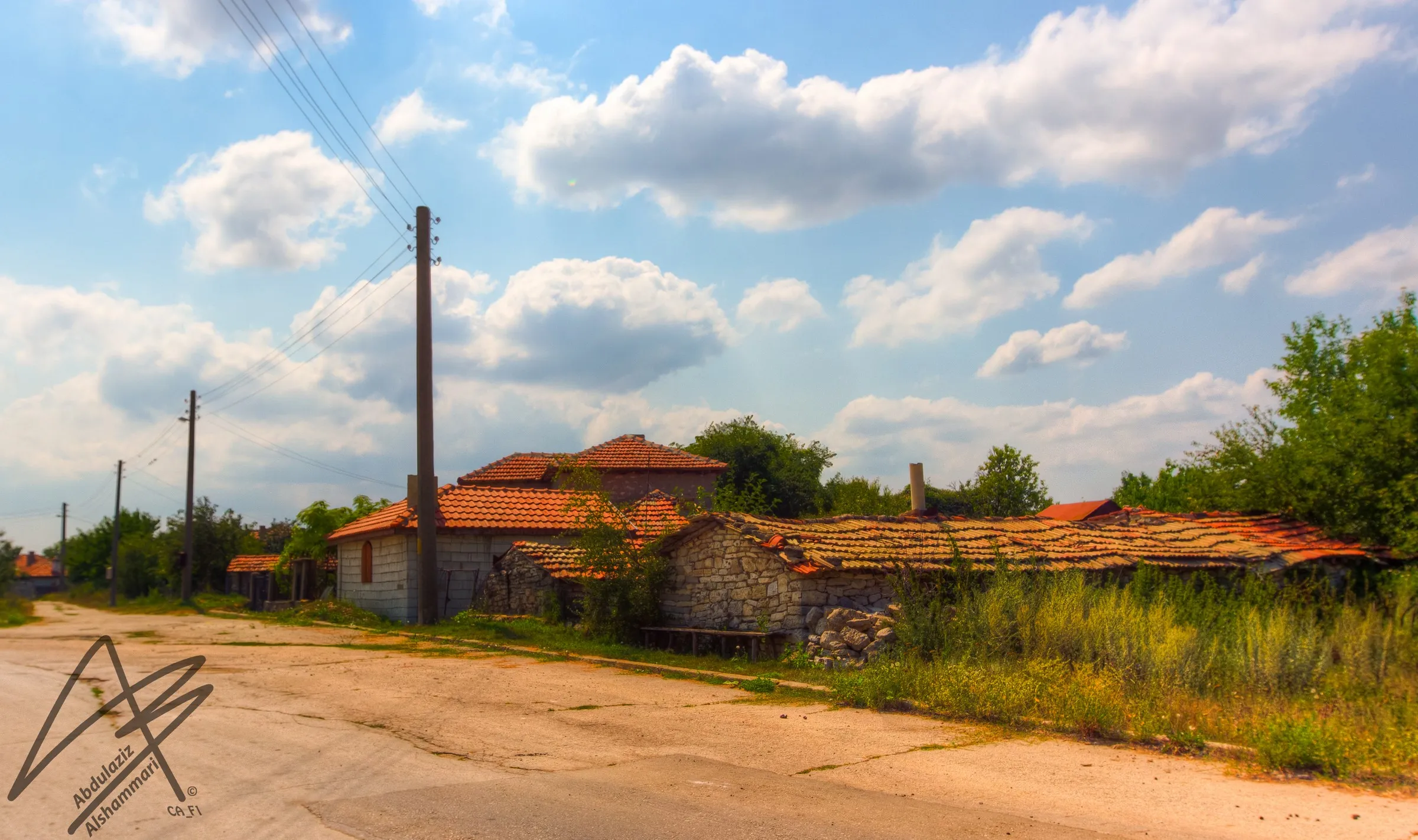 Village road under summer clouds