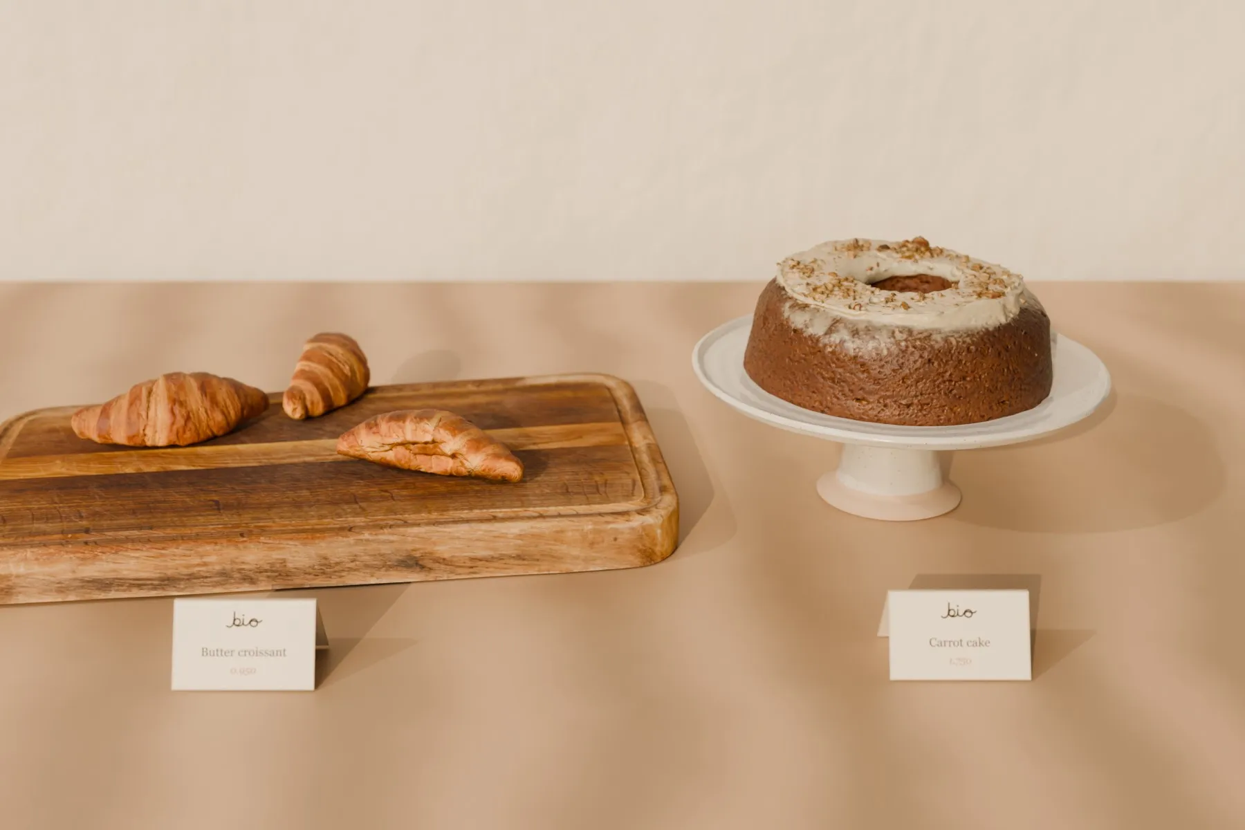 Croissants on oak, carrot cake on a thrown stand
